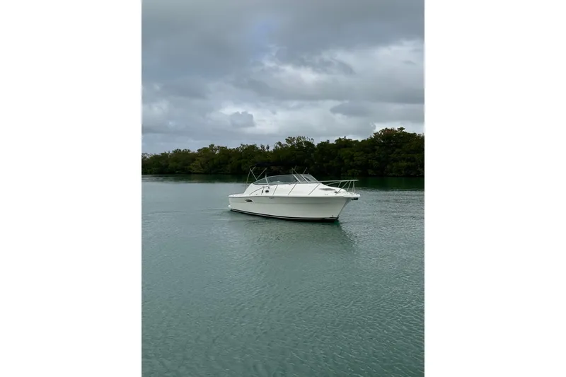 Slide: The Image of 2000 Riviera 3000 Offshore boat on calm water under cloudy sky. - 20