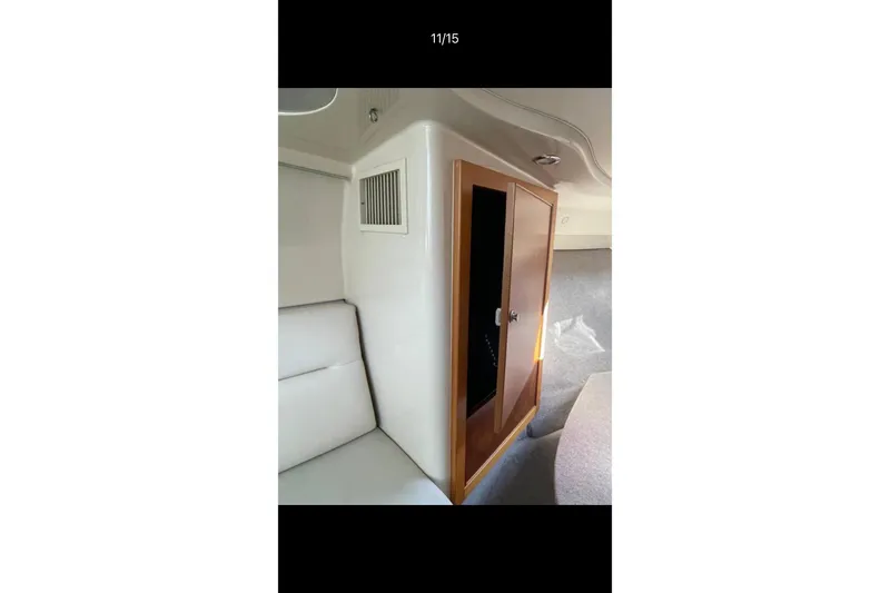 Slide: The Image of Interior of 2000 Riviera 3000 Offshore boat with wooden door and seating area. - 22