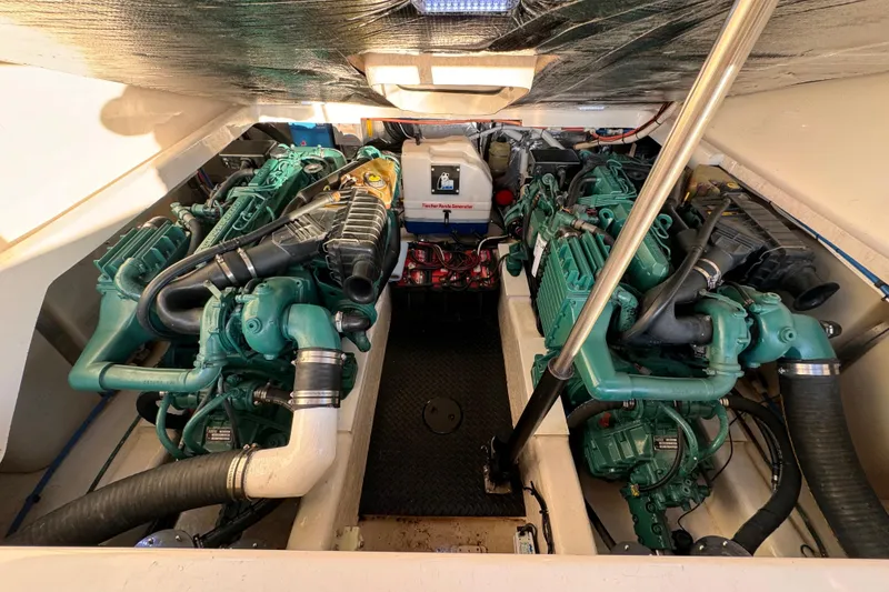 Slide: The Image of Engine room of 2000 Riviera 3000 Offshore boat with twin engines and mechanical components. - 25