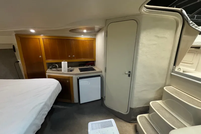 Slide: The Image of Interior of 2000 Riviera 3000 Offshore boat with kitchenette and stairs. - 4