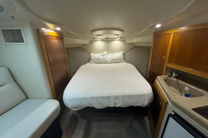 Slide: The Image of Interior cabin of 2000 Riviera 3000 Offshore with bed, sink, and seating area. - 5