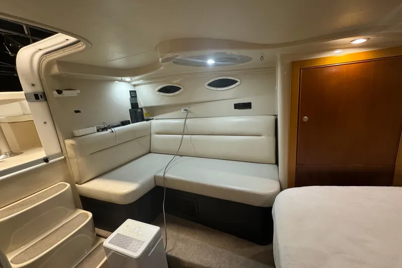 Slide: The Image of Interior of a 2000 Riviera 3000 Offshore yacht with beige seating and wooden accents. - 6