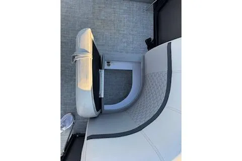 Slide: The Image of 2023 Angler Quest 8522 All Sport boat interior with gray seating and flooring. - 10