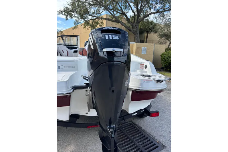 Slide: The Image of 2023 Tahoe 200 S boat with Mercury 115 outboard motor, parked outdoors. - 6