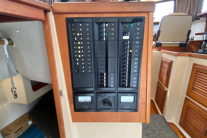 Slide: The Image of Electrical panel inside a 2010 Ranger Tugs R-29 boat, featuring switches and meters. - 12