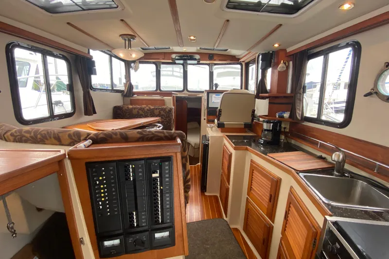 Slide: The Image of Interior of 2010 Ranger Tugs R-29 boat with wood accents and modern amenities. - 14