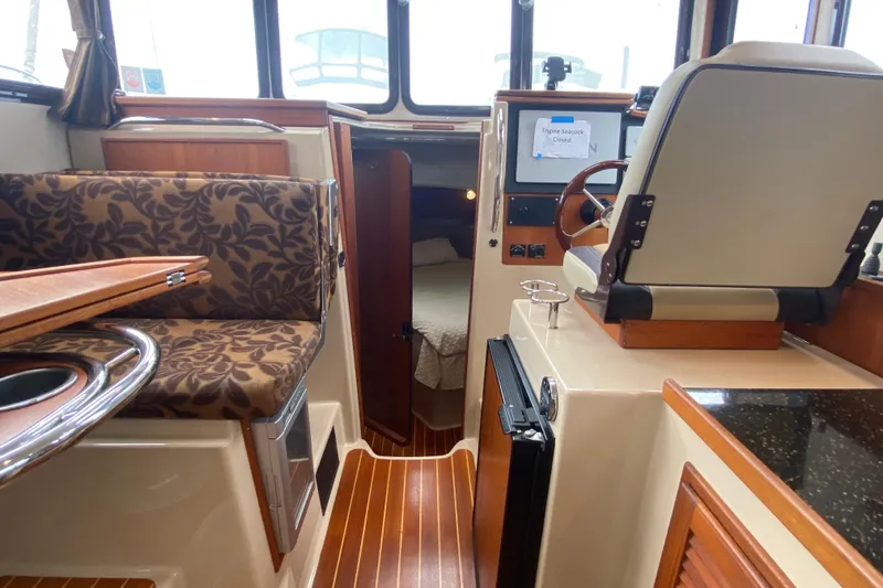 Slide: The Image of Interior of 2010 Ranger Tugs R-29 boat with seating, helm, and cabin view. - 18