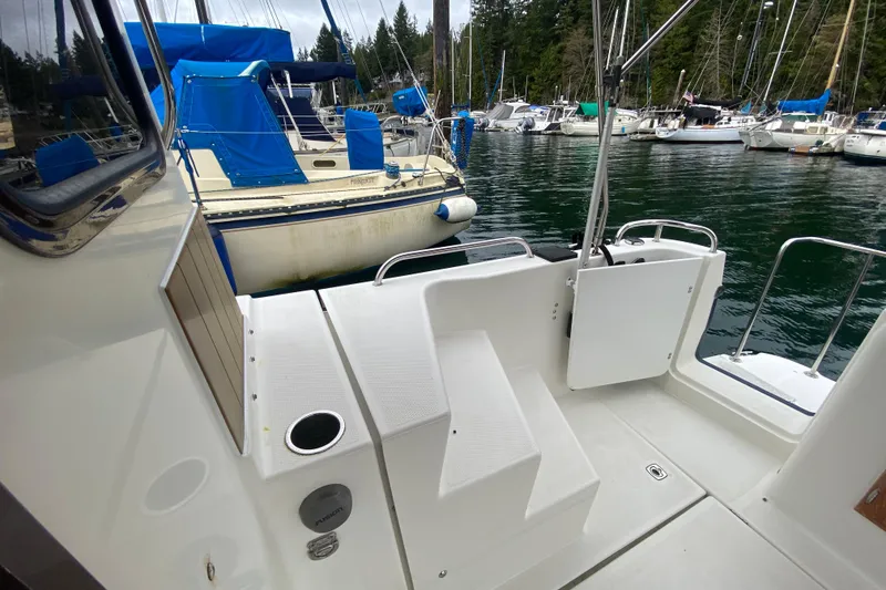 Slide: The Image of 2010 Ranger Tugs R-29 boat deck with marina view, featuring nearby sailboats. - 31
