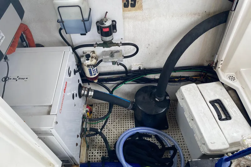 Slide: The Image of Engine compartment of 2010 Ranger Tugs R-29 with Cummins Onan generator and various components. - 33