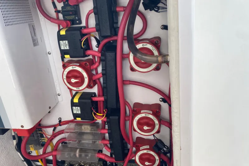 Slide: The Image of Electrical panel with red cables and switches on a 2010 Ranger Tugs R-29 boat. - 34