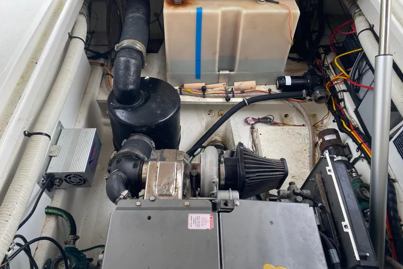 Slide: The Image of Engine compartment of a 2010 Ranger Tugs R-29 boat, showcasing mechanical components. - 35