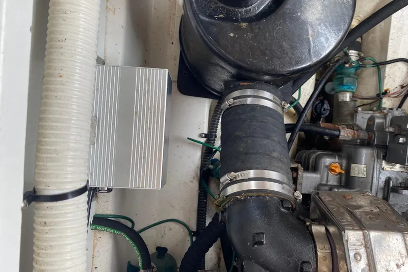 Slide: The Image of Engine compartment of a 2010 Ranger Tugs R-29 boat, showing hoses and mechanical components. - 36