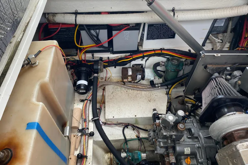 Slide: The Image of Engine compartment of a 2010 Ranger Tugs R-29, showcasing mechanical components and wiring. - 37