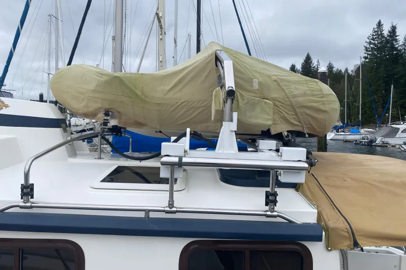 Slide: The Image of 2010 Ranger Tugs R-29 boat with covered equipment on deck, docked at marina. - 6