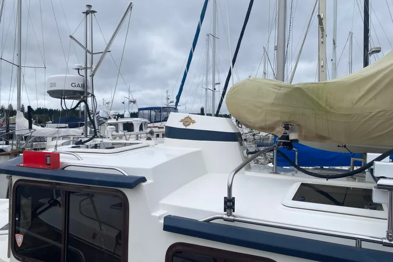 Slide: The Image of 2010 Ranger Tugs R-29 boat docked, featuring radar equipment and covered lifeboat. - 7