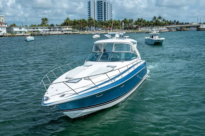 Slide: The Image of 2022 Formula 40 Performance Cruiser navigating coastal waters, with modern buildings in the background. - 11