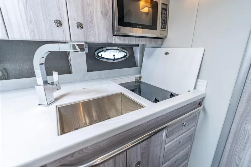 Slide: The Image of Modern kitchen in 2022 Formula 40 Performance Cruiser with sink, stove, and microwave. - 27