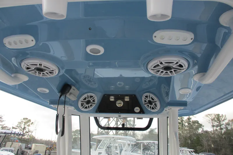 Slide: The Image of 2026 Sportsman Masters 267OE Bay Boat interior with speakers and controls on blue ceiling. - 10