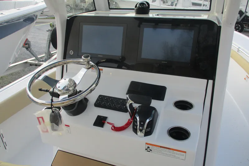 Slide: The Image of 2026 Sportsman Masters 267OE Bay Boat dashboard with dual screens and steering wheel. - 11