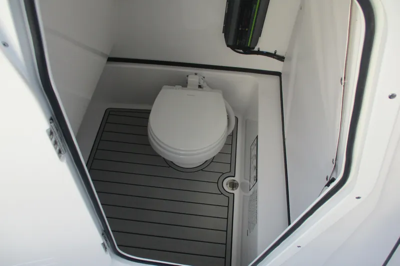 Slide: The Image of 2026 Sportsman Masters 267OE Bay Boat interior with compact marine toilet. - 17