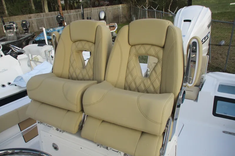 Slide: The Image of Luxurious seating on 2026 Sportsman Masters 267OE Bay Boat, featuring tan leather upholstery. - 18