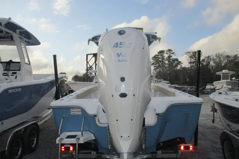 Slide: The Image of 2026 Sportsman Masters 267OE Bay Boat with powerful outboard engine, parked outdoors. - 3