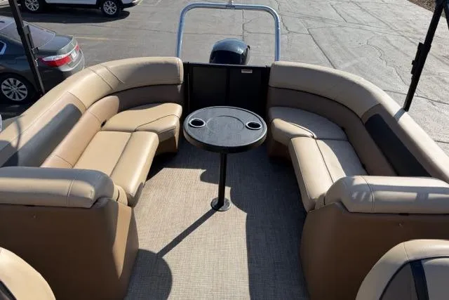 Slide: The Image of 2022 Viaggio Lago 22U pontoon boat with tan seating and round table. - 26