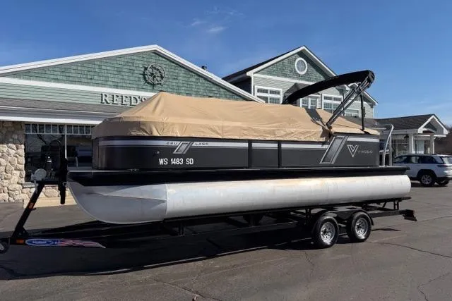Slide: The Image of 2022 Viaggio Lago 22U pontoon boat on trailer, parked outside a building. - 31