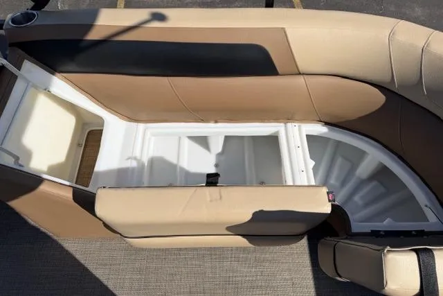 Slide: The Image of 2022 Viaggio Lago 22U boat interior with beige seating and storage compartment. - 7