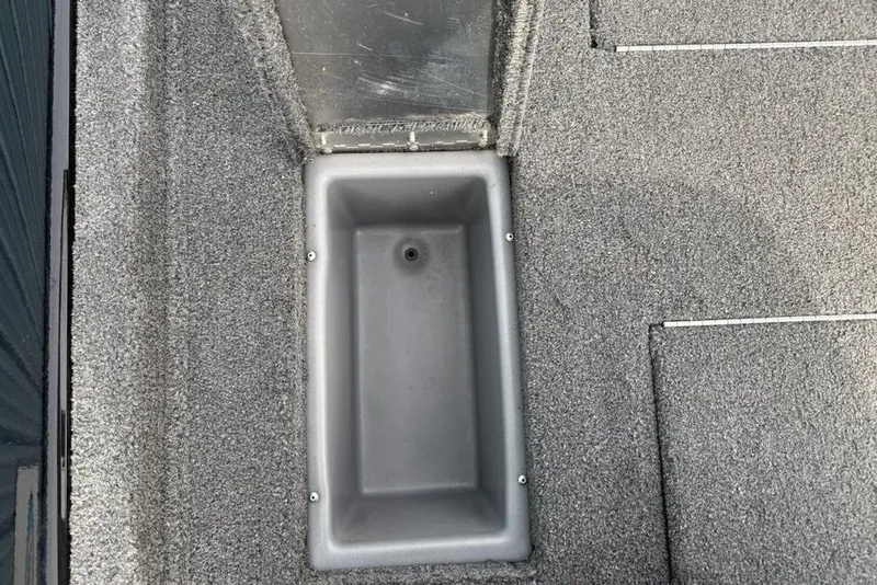 Slide: The Image of 2018 Tracker Pro Team 175 TXW boat storage compartment with gray carpeted interior. - 21