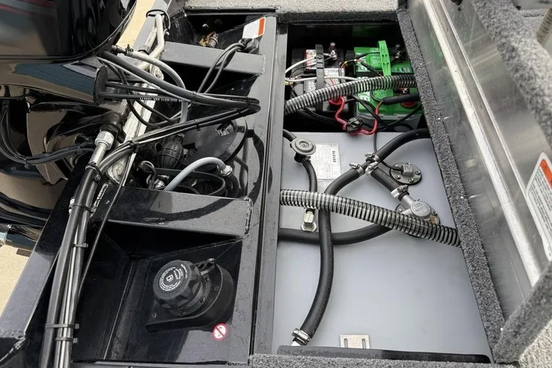 Slide: The Image of 2018 Tracker Pro Team 175 TXW boat engine compartment with wiring and battery setup. - 26