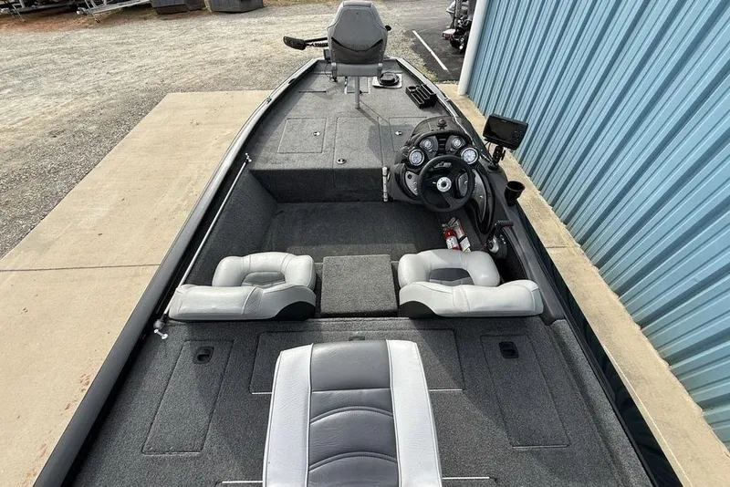 Slide: The Image of 2018 Tracker Pro Team 175 TXW boat interior with steering console and seating. - 27