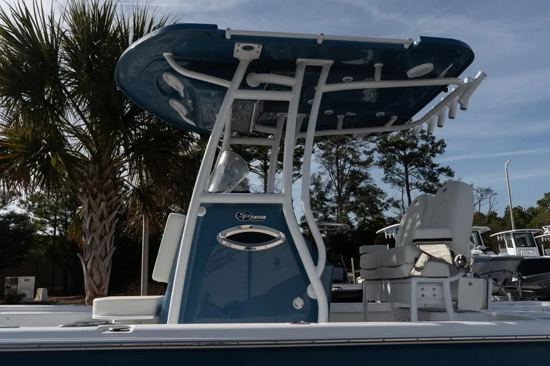 Slide: The Image of 2026 Sea Pro 230 Bay boat with T-top and seating, set against a palm tree backdrop. - 11