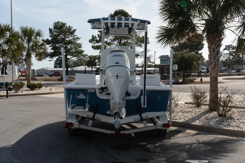 Slide: The Image of 2026 Sea Pro 230 Bay boat on trailer, parked near palm trees. - 12