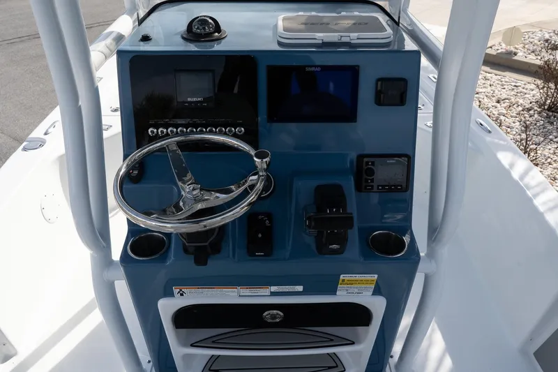 Slide: The Image of 2026 Sea Pro 230 Bay boat console with steering wheel and navigation controls. - 7