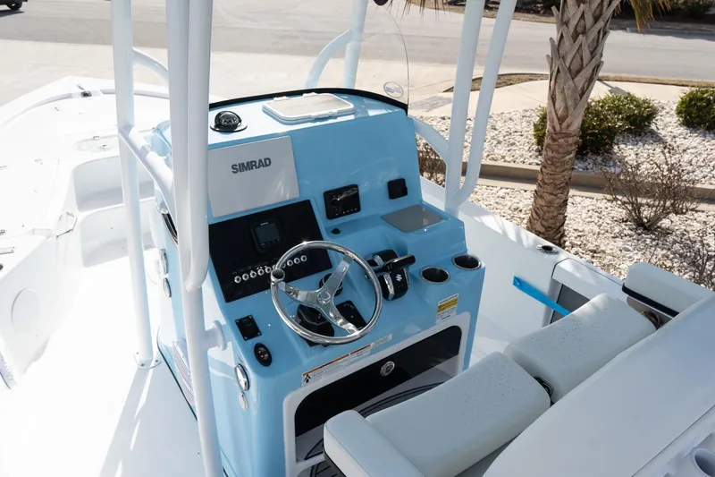 Slide: The Image of 2026 Sea Pro 250 Bay boat console with Simrad electronics and steering wheel. - 10