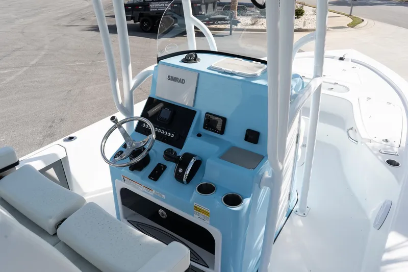 Slide: The Image of 2026 Sea Pro 250 Bay boat console with steering wheel and navigation controls. - 11
