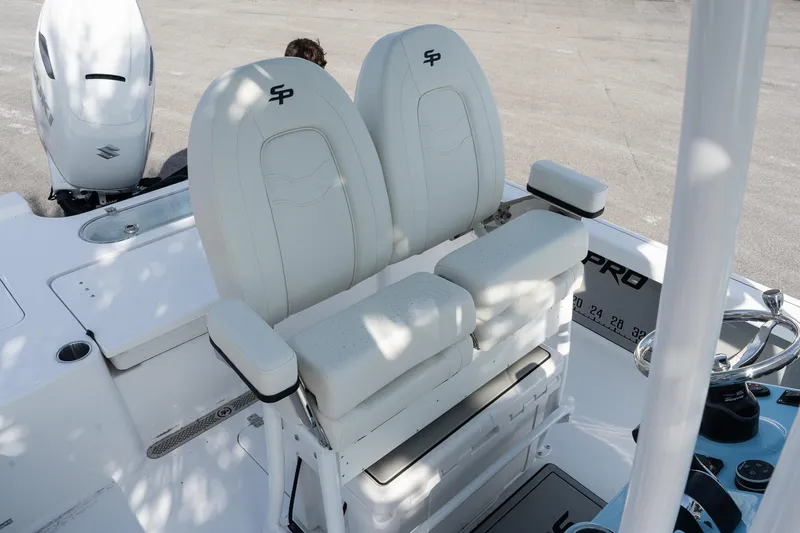 Slide: The Image of 2026 Sea Pro 250 Bay boat with dual white captain's chairs and steering console. - 12