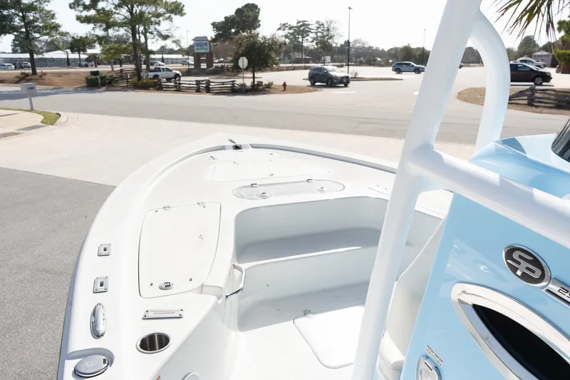 Slide: The Image of 2026 Sea Pro 250 Bay boat, white deck, blue exterior, parked outdoors. - 15
