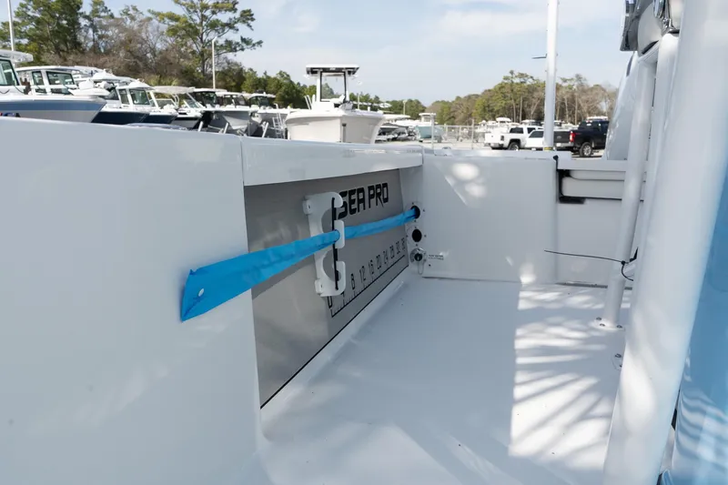 Slide: The Image of 2026 Sea Pro 250 Bay boat interior with storage compartment and rod holder. - 17