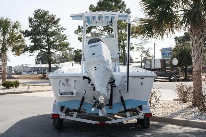 Slide: The Image of 2026 Sea Pro 250 Bay boat on trailer, parked outdoors with palm trees. - 4