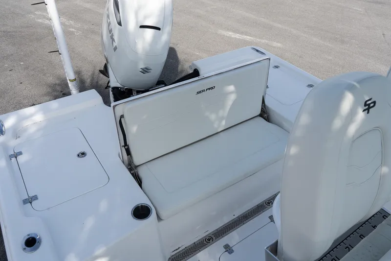 Slide: The Image of 2026 Sea Pro 250 Bay boat interior with Suzuki engine, featuring white seating and storage compartments. - 7