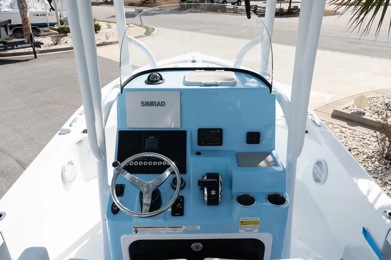 Slide: The Image of 2026 Sea Pro 250 Bay boat dashboard with steering wheel and Simrad navigation system. - 9