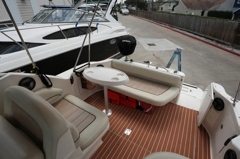 Slide: The Image of 2000 Sea Ray 270 Sundancer boat interior with seating and table on deck. - 11