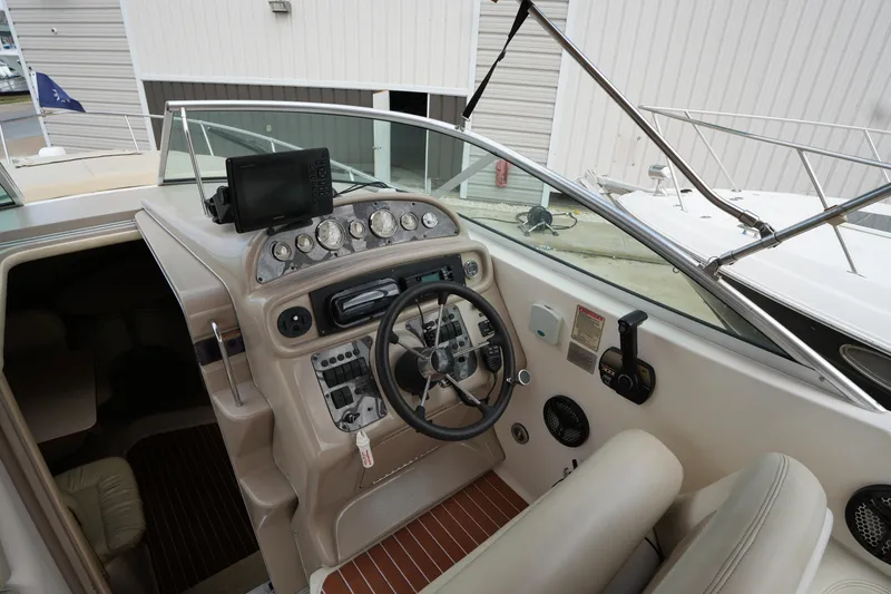 Slide: The Image of Cockpit of 2000 Sea Ray 270 Sundancer with steering wheel and control panel. - 14