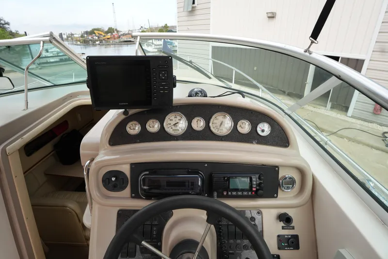 Slide: The Image of 2000 Sea Ray 270 Sundancer boat dashboard with gauges and navigation equipment. - 15