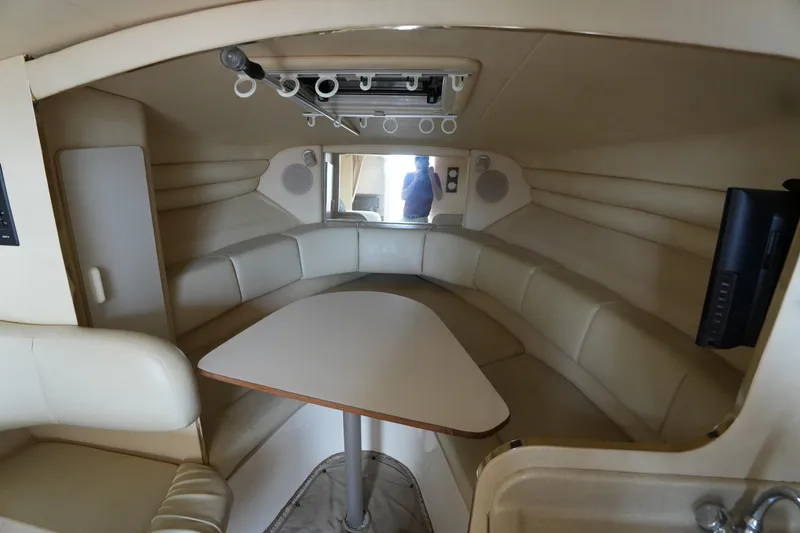 Slide: The Image of Interior of 2000 Sea Ray 270 Sundancer boat with beige seating and table. - 18