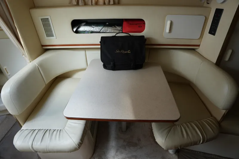 Slide: The Image of Interior of 2000 Sea Ray 270 Sundancer with dining area and emergency kit. - 21