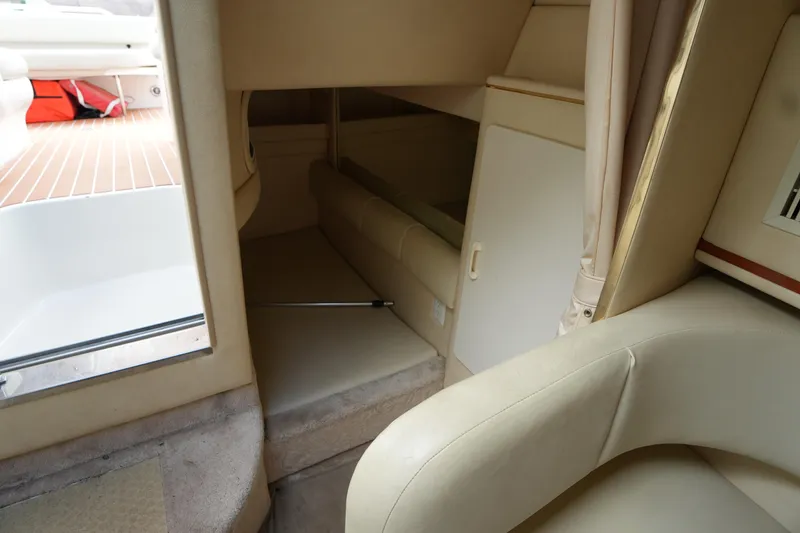 Slide: The Image of Interior cabin of 2000 Sea Ray 270 Sundancer boat, featuring seating and storage. - 23