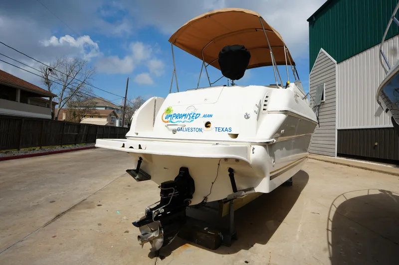 Slide: The Image of 2000 Sea Ray 270 Sundancer boat with canopy, parked on concrete, Galveston, Texas. - 5